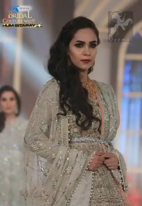 Light fawn pure chiffon dress with stunning embellishment on the blouse, lehenga, and dupatta. The dupatta contains a border on