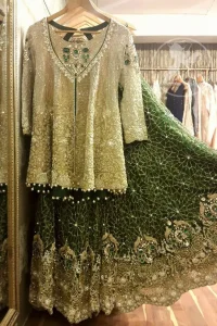 The front open short shirt features marvellous and awesome embellishments accent all over the front and sleeves. Embellished border implemented at the bottom of shirt. Full-length sheer sleeves and Lehenga feature beautiful scalloped work crafted on the bottom with Stunning pearls spray on the bottom.