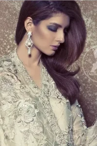 Light Gray Aline Short Dress features beautiful and lovely embellishments that accentuate the neckline, all over the bodice. Full sleeves and Embellished border implemented on front and back hemline. Silk cigarette pants come with a fixed waistband with a side zip closure. Stones spray scattered all over the dupatta.