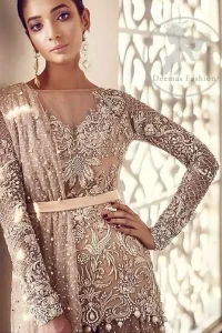 The shirt features beautiful and lovely embellishment all over the bodice, front flared, and applique work border on the hemline. Lehenga contains pearls and stones sprayed all over and comes with a flared-back trail lehenga.