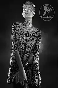 The stylish black front open velvet cape has been embellished heavily on the front and back having a sherwani neckline. Embroidery on this stylish party wear includes antique and dark antique shades of kora, dabka, naqshi, beads, sequins, tilla, etc.