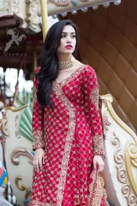 Pure banarsi chiffon jamawar gharara in Cardinal Pink and Mehndi Green. Cardinal pink self embroidered chiffon angrakha style gown. Gown adorned with dull golden and antique shades of embellishment. Pure banarsi chiffon jamawar dupatta having embellished border and small motifs spray.