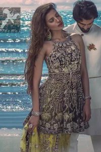 Charade net peplum having halter neckline. Peplum adorned with light golden, pearls and mix embellishment. Husk net sharara and dupatta. Sharara having hemline and small motifs spray all over it. Dupatta having zigzag border on sides, beautiful shapes of motifs on small sides (pallu) and appliqued with charade.