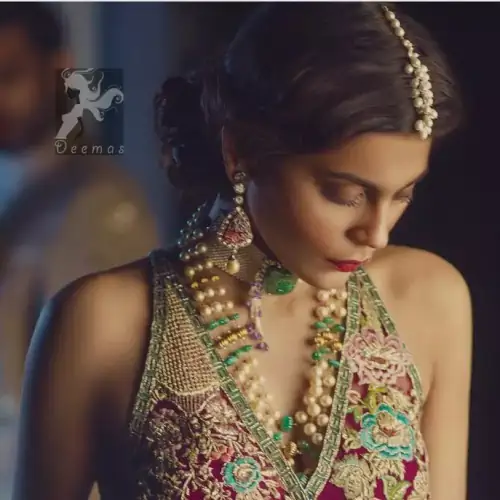 Claret colour peplum having halter neck design with bottle green loose trousers and heavy embellished Dupatta