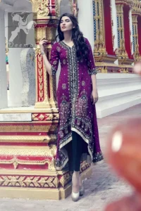 Dark purple front open back train gown. Gown having navy blue applique with silver embellishment. It comes with Navy blue churidar trousers and chiffon dupatta.