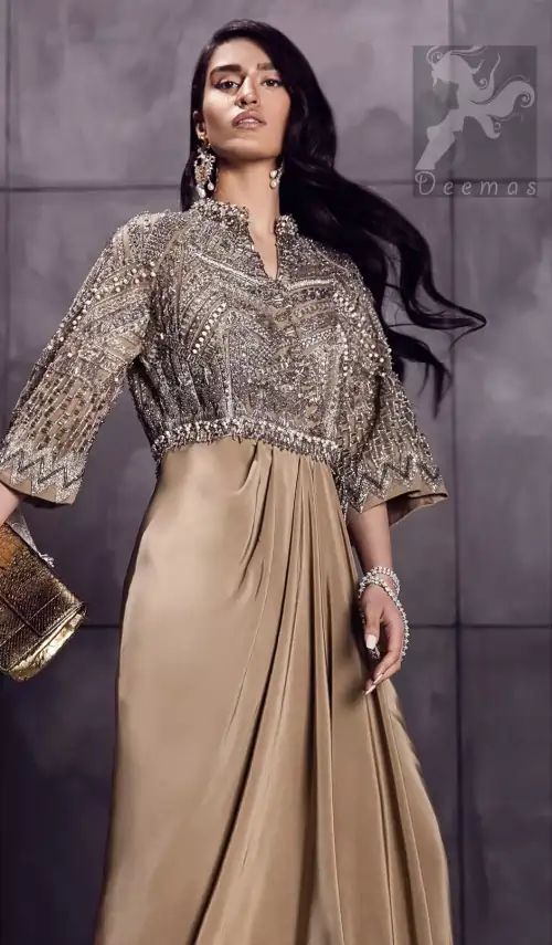 Fawn brown silky maxi has embellished bodice and sleeves. Bodice and sleeves have been embellished with dark gray embellishment and