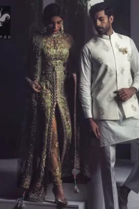 Pistachio green gown having high neck gown. Embellished Bodice with waist belt and front open slits. Mehndi green trousers having embellishment on cuffs and motifs. Pistachio green net dupatta having embellished border and round motifs all over it.