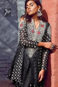 Black peplum made with pure banarsi jamawar chiffon. Peplum having multiple panels of different banarsi patterns. White and silver embellishment on neckline, side panels and sleeves. Pure raw silk sharara pants.