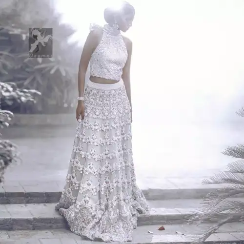 White choli / blouse having beautiful embellishment in white, silver and maroon brown. Halterneck design has been implemented on blouse