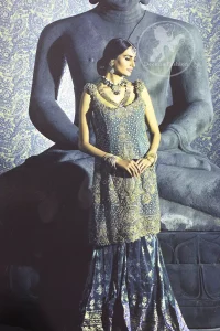 Bluish Slate Gray velvet shirt has been adorned with antique shades of embellishment.Embellished 3d motifs has been applied on shoulders. Brocade lehengha / skirt having embellished border on the hemline.