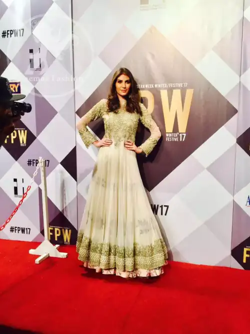 Ivory floor length Anarkali embellished with floral embroidery. Front and back bodice is fully embroidered with dull golden and antique