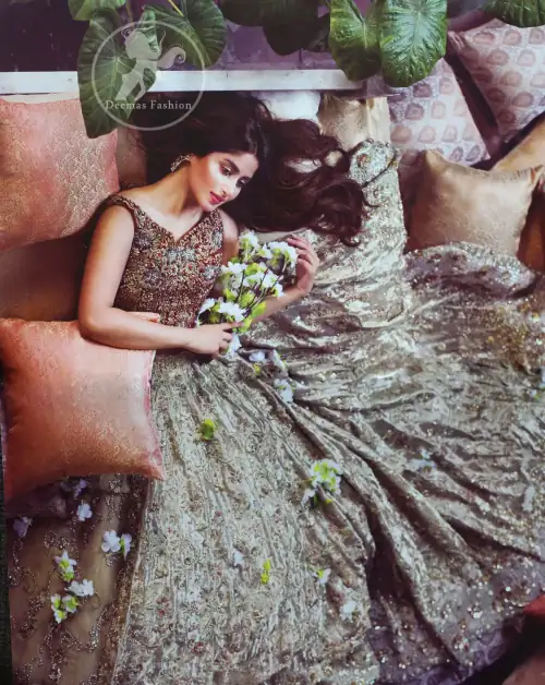 Redish brown exuberant velvety blouse is highlighted with moti, kora, dabka, pearls, swarovski, crystals, and sequins. This sleeveless blouse is