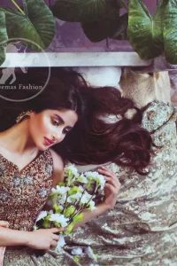 Redish brown exuberant velvety blouse is highlighted with moti, kora, dabka, pearls, swarovski, crystals, and sequins. This sleeveless blouse is allured with gorgeous shades of zari embroidery . It has V shaped neckline. Lehengha is of grey colour, adorned with beautiful different shaded embellishment.  Lehengha is decorated with floral pattern. It is artistically coordinated with brown dupatta which  is decorated with floral and sequins pattern all over it