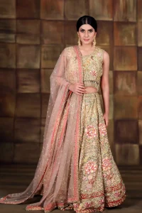 This dress is beautifully sculptured with floral thread embroidery. Blouse is fully embellished and decorated with tassels. Lehengha is embellished with different shaded thread embroidery, allured with kora, dabka, tilla, sequins and pearls. It comes with net dupatta which has four sided embroidered border and sprinkled with pearls and sequins all over it.