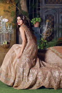 This dress is beautifully sculptured with floral embroidery. It is meticulously highlighted with silver kora, dabka, tilla, sequins and pearls. Back is fully embroidered. Trail is magnificently decorated with scalloped border. Beautiful bodice adds to the look. Inner of this trail is of brocade which has thick embellished border. Complete the look with embellished dupatta.