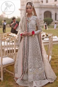 This outfit is a timeless beauty.It is heavily embellished with silver gold kora dabka, Sequins and swaronski crystals.This exquisite Pishwas is fully decorated with floral motifs patterns all over it.It is further enhanced with Foral thread embroidery.The trimming border of pishwas is ornamented with small golden pearls. It comes with embellished lehengha which has small sized sprinkled floral motifs all over.This Outfit is beautifully coordinated with matching Dupatta with heavy embroidered borders.