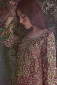 Copper Rose Shirt Vanilla Trousers. It is adorned with a criss-cross design. This shirt is meticulously highlighted with dull golden and antique shaded kora, dabka, tilla, sequins and pearls.