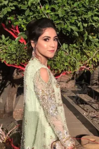 This short frok is decorated with thread, kora, dabka, tilla, sequins and swarovsky. It is embellished with floral thread embroidery. Sleeves are fully embroidered and adorned with cold shoulder design. It is decorated with intricate cutwork on hemline. It is further enhanced with embroidered scalloped border on hemline which adds to the look. It comes with brocade bell shaped pants. It is beautifully coordinated with chiffon dupatta which is sprinkled with sequins all over it.