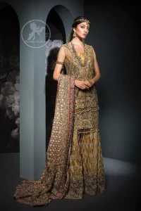 This dress is beautifully sculptured with floral embroidery. It is meticulously highlighted with antique shaded kora, dabka, tilla, sequins and pearls. It is allured with beautiful tassels which adds to the look. It is beautifully paired up with embroidered brocade sharara. It comes with organza/tissue dupatta which has four sided embellished border and applique.