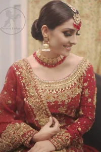 This dress is beautifully sculptured with floral embroidery. It is allured with red, dull golden, champagne and antique shaded kora dabka, tilla, sequins and pearls. It is adorned with beautiful U-shaped embellished neckline which adds to the look.It is artistically coordinated with rust embellished lehenga. It comes with burnt red dupatta which has heavy work on pallu and four sided embroidered border. Dupatta is sprinkled with small sized floral motifs all over.