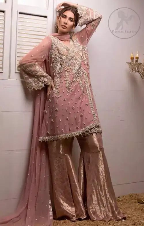 This outstanding copper rust angrakha meticulously highlighted with dull golden, tea pink and silver shaded kora, dabka , tilla, sequins