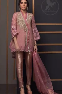 This outstanding angrakha style shirt meticulously highlighted with dull golden and antique shaded kora, dabka , tilla, sequins and pearls. This dress is beautifully adorned with floral embroidery. Sleeves are decorated with resham embroidery which adds to the look. It comes with brocade pajama. It is beautifully coordinated with chiffon dupatta having sprinkled sequins all over it.
