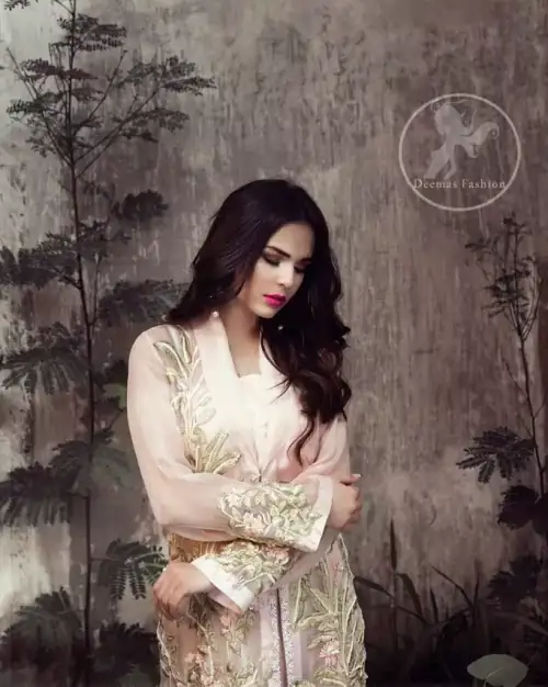 This dress is beautifully sculptured with floral embroidery. It is adorned with kora, dabka, tilla and thread embroidery. It is