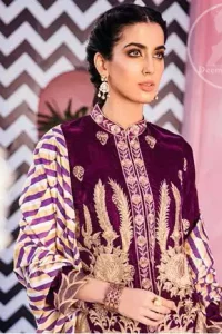This outfit is a timeless beauty. It is embellished with golden kora, dabka, tilla and kundan. This shirt is fully decorated with floral motifs all over it. Round collar neckline ornamented with small sized floral patterns. It is further enhanced with golden floral thread embroidery. It comes with magenta shalwar which has small sized sprinkled floral motifs all over. This Outfit is beautifully coordinated with multiple colored lining dupatta.