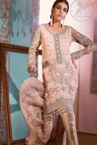 This outfit is decorated with silver kora, dabka, tilla, sequins and pearls. This dress is embellished with floral embroidery and intricate embroidered hemline. It is adorned with beautiful tassels which adds to the look. Sleeves are fully embellished. Trail is also embellished. It comes with brocade pajama. It is coordinated with chiffon dupatta which is sprinkled with sequins all over it.