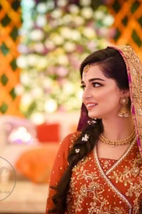 This outstanding outfit is fully embellished with embroidery. It is allured with resham, kora dabka, tilla and pearls. Sleeves are decorated with floral embroidery. Its neckline and hemline is adorned with floral motifs.It comes with embellished sharara which has small sized sprinkled floral motifs at the bottom. This Outfit is beautifully coordinated with dull yellow dupatta with heavy embroidered borders.