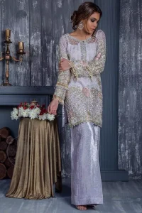 Standout in this gorgeous chiffon shirt embellished with tilla, kora dabka, sequins and pearls.It is further enhanced with floral thread embroidery.Its hemline and sleeves are beautifully decorated with golden tassels.It is beautifully coordinated with self print jacquard trousers. It comes out with chiffon dupatta decorated with sequins spray all over .