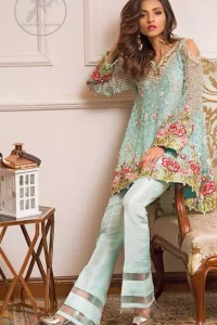 This outstanding self embroidered short frock embellished with floral thread embroidery. It is allured with resham kora dabka tilla and pearls. Sleeves are decorated with cold shoulders design and floral embroidery. Scalloped hemline ornamented with tassels. It is beautifully paired up with matching bell bottom trouser. It comes with light blue dupatta sprinkled with sequins all over it.