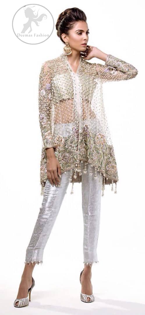 This classic outfit meticulously highlighted with silver golden kora, dabka ,tilla, sequins and pearls. This dress is beautifully sculptured with floral embroidery. The shirt is decorated with tassels and floral motifs on hemline which adds to the look. It comes with brocade pajama and beautifully decorated with net dupatta having sprinkled sequins all over it.