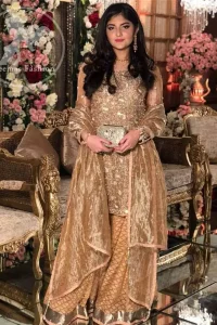 Take a step towards refreshing your wardrobe with this regal dress. The shirt is beautifully adorned with golden kora dabka, kundan, tilla and sequins work along net sleeves. The self-printed brocade sharara is enhanced with lace detail on bottom. It comes with organza dupatta sprinkled sequins on ground.