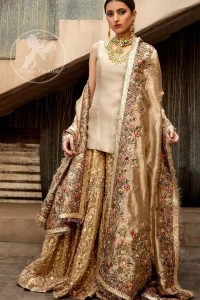 Ivory plain shirt is paired up with golden traditional gharara done with floral motifs all over. It is beautifully matched with golden dupatta with colorful embellished motifs at both lengths and lace border finished around dupatta.
