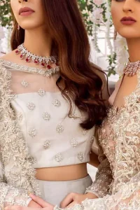 This super stunning skirt is made of rich floral embroidery which is further enhanced with kora dabka work. Blouse is meticulously embellished from neckline and sprinkled floral motifs on ground. It is paired up with ivory dupatta embellishment on sides which looks so breathtaking elaborate it with crisscross lines.