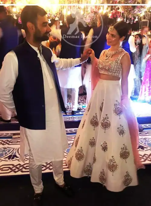 The blouse is beautifully embellished with cutwork embroidery enhanced with silver gold kora dabka, kundan and sequins work. It is