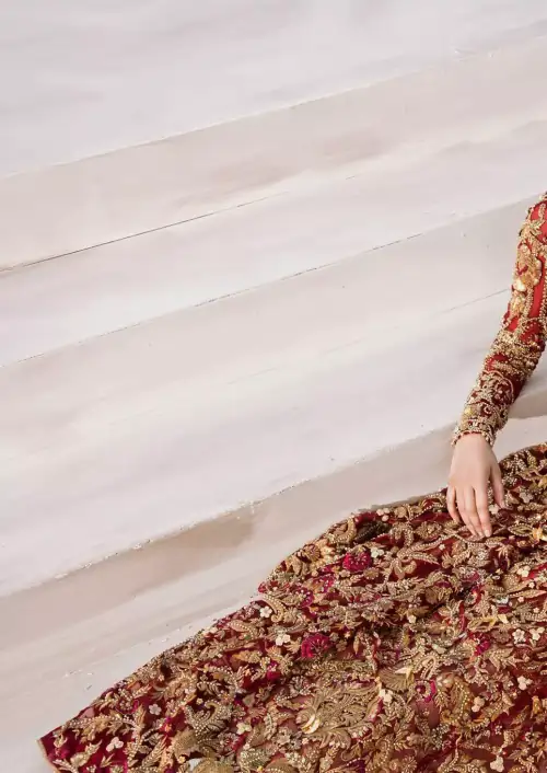The grand maroon bridal stands out due to its uniqueness and the perfect fusion of modern cut and traditional embroidery.