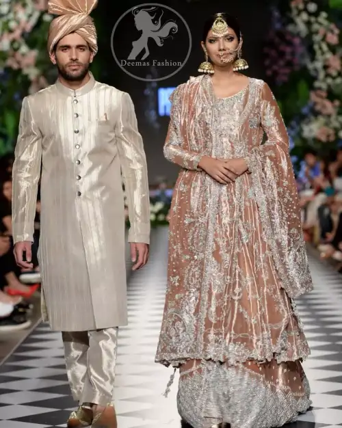 This dress is beautifully decorated with heavy embroidery. It is highlighted with kora, dabka, tilla, sequins and pearls. It comes