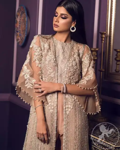 This dress is decorated with floral embroidery. It is highlighted with kora, dabka, tilla, sequins and pearls. Gown is adorned