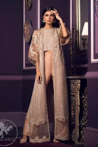 This dress is decorated with floral embroidery. It is highlighted with kora, dabka, tilla, sequins and pearls. Gown is adorned with scalloped border and tassels which adds to the look. It comes with trousers. It is coordinated with organza dupatta which is sprinkled with sequins all over it.