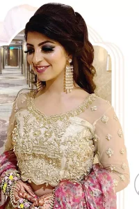 This dress is adorned with floral embroidery, highlighted with kora, dabka, tilla, sequins and pearls. It is allured with intricate embroidered motifs and detailed bodice. Blouse is scalloped. The border on hemline is enhanced with embellished floral pattern detailing, that instantly draws attention.It comes with embellished net lehengha with brocade lining. It is artistically coordinated with net dupatta which is allured with four sided border.