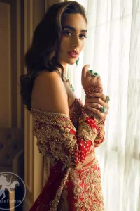 This bridal blouse executing heavily handcrafted art of zardozi. This dress is beautifully decorated with heavy embroidery. It is highlighted with kora, dabka, tilla, sequins and pearls. It comes with an exquisite back trail lehengha with thick embroidered borders to give it a regal look. It is coordinated with chiffon dupatta which is allured with zikzak pattern and four sided embellished scalloped borders.