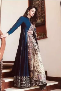 Look alluring in this floor length frock embellished with kora, dabka, tilla, sequins and pearls. The border on the daman is enhanced with embellished floral pattern, detailing that instantly draws attention. It comes with matching cigarette pants. Multiple panels adds to the look. It is paired up with embroidered shawl with sequins sprinkled and finished with light embroidered edges.