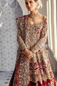 Look alluring in this floor length frock embellished with kora dabka, tilla, swarovsky and pearls. It has intricate embroidered motifs and detailed bodice. The border on the daman is enhanced with embellished floral pattern detailing that instantly draws attention. Heavy back trail frock adds to the look. It comes with matching pajama. It is paired up with heavy embroidered dupatta.