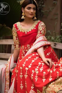 Exude elegance and class in this anarkali frock finessed with beautiful hand crafted embellishment. Embellished neckline and three quarter sleeves enhanced the look. It is further enhanced with verticle styled lines done with golden gotta work. It comprises with detail on bottom. Paired up with churidar pajama and ivory dupatta which is having embroidered border on sides.