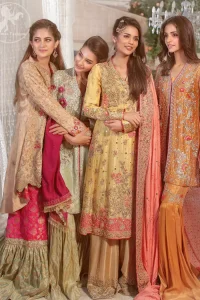 This outfit is perfect for mehendi mayon day. Heavily embellished in the front with intricate embroidered pattern done with golden kora dabka, kundan, tilla and sequins. Hemline is enhanced with peach embellished border adorned with kora dabka and thread embroidery. It is paired up with antique brass sharara with zerdosi work details on bottom. Dupatta having four sided embroidered edges and sequins spray.