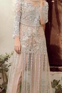 Exude elegance and class in this shirt finessed with beautiful embellished daaman. This dress is beautifully decorated with heavy embroidery. It is highlighted with silver kora, dabka, tilla, sequins and pearls. Bodice is ornamented with heavy embellishment and addition of tassels to complete the look. It comes with matching capri. It is coordinated with chiffon dupatta which is sprinkled with sequins all over it.