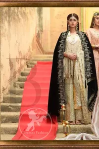This outfit is beautifully sculptured with floral embroidery. It is further enhanced with kora, dabka, tilla, sequins and pearls. The daaman is emphasized with intricate details that gives perfect ending to this peplum. It is coordinated with straight trousers embellished with embroidery. The banarsi jamawar dupatta has scattered sequins all over. It is finished with jamawar piping all around the edges. It is allured with black embroidered shawl which adds to the look.