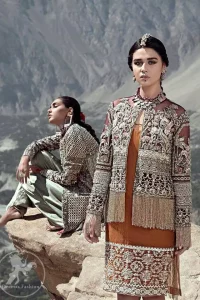 Tradition meets modernity. Delicately crafted and personifying chic elegance with an element of grandiose. This super stunning shirt is made of rich floral embroidery which is further enhanced with zardoze and gota work. The hemline is enhanced with detailed floral embroidery. It comes with front open jacket executing heavily hand crafted art of zardozi, kora, dabka and floral thread embroidery. This outfit is paired up with matching pajama. It is coordinated with chiffon dupatta which is sprinkled with sequins all over it.